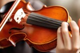 Close-up of a violin being played by a musician's hand.