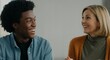 © Postmodern Studio - African male teen and caucasian female mature interaction in casual setting