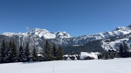 Fototapete - Winter scenery of a ski resort in French alps with wooden chalets on the slope