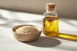 © Michael - Sesame oil in a glass bottle is standing next to a bowl of sesame seeds, creating a visually appealing arrangement