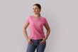 © New Africa - Woman in pink t-shirt on grey background. Mockup for design