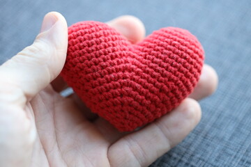 Poster - A person holding a handmade crochet heart, perfect for expressing love and affection.