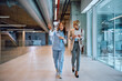 © Drazen - Medical sales representative communicating with nurse while walking through clinic.
