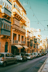 Naklejka na meble Typical narrow streets with colorful balconies in VallettaTypical narrow streets with colorful balconies. Narrow streets with colourful window boxes in Valetta, MaltaTraditional Maltese balconies in V