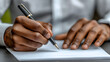 © Design_Stock - Close-up of Person's Hands Writing with a Pen on White Paper