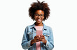 © Pete - Smiling african student girl with afro hairstyle holds pink phone, looks at camera. Modern pretty woman in glasses uses smartphone. Isolated portrait on white, college girl, social media user.