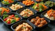 © Pete - Variety of ready meals in black containers salads, couscous, meat, vegetables for diet nutrition. Take away service of tasty prepared lunch or dinner. Balanced daily ration on doorstep.