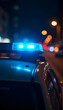 © Zilvinas - Blue police car lights flashing in nighttime city traffic for urgent emergency response and public safety.