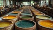 © Auraclicks - Rustic leather tannery with large vats of natural dyes hides soaking in colorful solutions and workers preparing the leather for luxury goods production