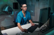 © pressmaster - Medical professional in scrubs monitoring patient MRI scan in a controlled environment within a medical facility