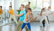 © JackF - Group of children boys and girls dance energetic pair dance twist in studio