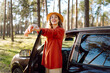© maxbelchenko - Beautiful woman near car and enjoy the nature around - concept of off grid vacation and trip with wood and trees - people enjoy the outdoor leisure activity with vehicle