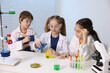 © New Africa - Children doing chemical experiment at desk indoors