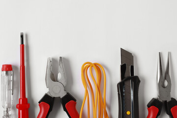 Poster - Different electrical tools on light background, flat lay. Space for text
