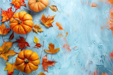 Poster - Orange Pumpkins and Autumn Maple Leaves on a Blue Textured Background