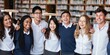 © Rawpixel.com - Group of diverse students in a library. Students in uniforms, library setting. Happy students, diverse group, library environment. Young diverse students learning together in library.