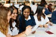 © Rawpixel.com - Diverse group of young women studying together. Women using laptops, collaborating, and learning. Female students, diverse ethnicities, engaged in group study. Young women in high school education.