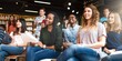 © Rawpixel.com - Diverse group of students in a classroom, smiling and attentive. Young adults, engaged in learning. Classroom setting with diverse students. International high school students in seminar.