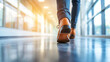 © Nasim Reza - Businessman walking in an office building, close-up of shoes and legs with focus on a leather dress shoe wearing suit pants