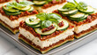 © siraphol - Delicious raw vegan lasagna layered with zucchini, cashew cheese, and sun dried tomatoes