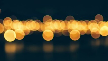 Poster - A blurry line of bright yellow lights against a dark blue background bokeh effect view image