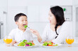 © Creativa Images - Mother giving healthy food on her son