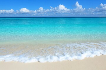 Poster - Crystal clear turquoise water gently laps against a sandy beach under a bright blue sky with fluffy white clouds