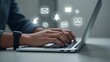 © IWonderStudio - Hands typing on laptop with floating digital icons representing apps, notifications, and technology concepts