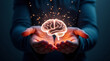© Konstantin - Glowing human brain in person's hands on dark background