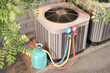 © Grispb - An outdoor air conditioning unit undergoing maintenance, with a refrigerant tank and manifold gauge set connected, ensuring proper cooling performance and system efficiency 3d image