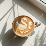 Latte art close up featuring a beautiful swan design in a cup of coffee.