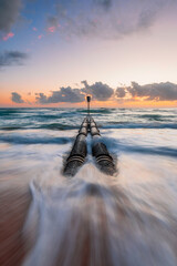 Wall Mural - morning view of stormwater pipe with waves at manly beach, sydney, australia.