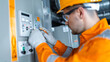 © Jack - Technician working on an electricity power meter station in a building for accurate energy consumption monitoring.