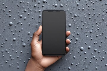 Aufkleber - Hand holding a smartphone against a textured gray background with droplets of water