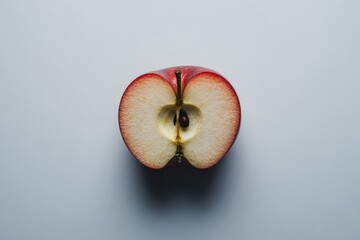 Aufkleber - Sliced red apple showcases juicy interior and smooth texture on a light background