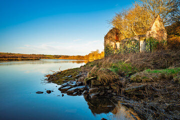 Wall Mural - derelict building on banks of river tweed at berwick. the river tweed is 97 miles long from source t