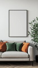 Poster - A chic living area features a light gray sofa adorned with colorful throw pillows, surrounded by greenery. The blank wall above invites creativity, perfect for displaying art