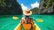© Chaiwit - Solo Female Travel, solo female traveler enjoys kayaking in serene turquoise lagoon surrounded by lush cliffs