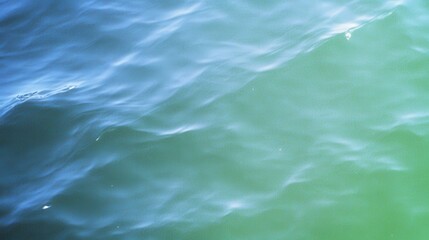Poster - A serene view of rippling water, showcasing a blend of blue and green hues, creating a calming and tranquil atmosphere.