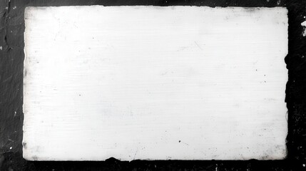 Poster - A plain, textured white surface on a dark backdrop, suggesting a minimalist aesthetic ideal for backgrounds or artistic projects.
