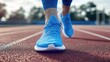 © Rakyandani - Close-up of a runner's feet in blue athletic shoes sprinting on a track with a blurred background of trees