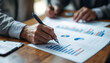© adiba sakila atmari - Financial Analysis: Businesspeople Reviewing Charts and Graphs