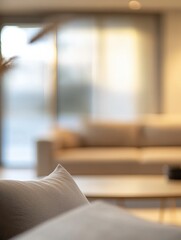 Poster - Blurred view of light living room with sofa and soft bench; unfocused background photo; selective focus
