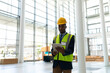 © WavebreakMediaMicro - Engineer in safety vest and hard hat using tablet in modern building, copy space