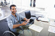 © wavebreak3 - Smiling man in wheelchair using smartphone at modern office desk, copy space