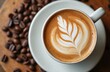 © Maryna - Delicious cup of cappucino with latte art served on wooden table. Coffee beans are scattered around. Top view of hot beverage, morning drink with design in foam.