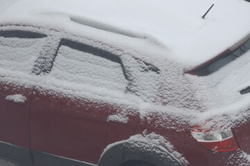 Poster - A red car covered in snow on a snowy day, perfect for winter scenes or festive themes.