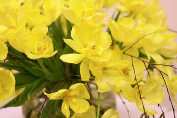 Poster - A vase filled with bright yellow flowers sits atop a table, ideal for adding a pop of color to any scene.