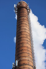 Poster - A tall brick tower with a clock on top, suitable for city or townscapes.