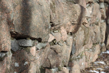 Poster - A close-up shot of a stone wall covered in snow, perfect for winter scenes or rustic backgrounds.